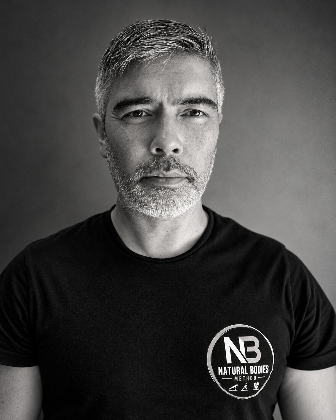 Black and white portrait of Eugene Salleh in an NBM t-shirt