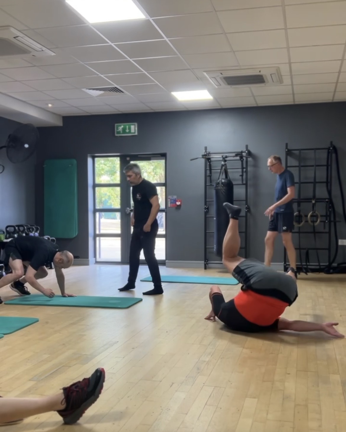 Eugene coaching a Small Group session while members move on the studio floor